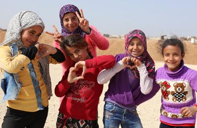 several Syrian girls smiling. Click to view Partner With Us